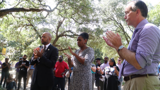 From left to right: LSU board member James Williams; Baton Rouge City Council member Tara Wicker; and LSU system president and LSU chancellor F. King Alexander listen to students at the LSU sign making and information meeting
